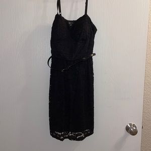 Black cocktail dress with a lace over lay and a belt